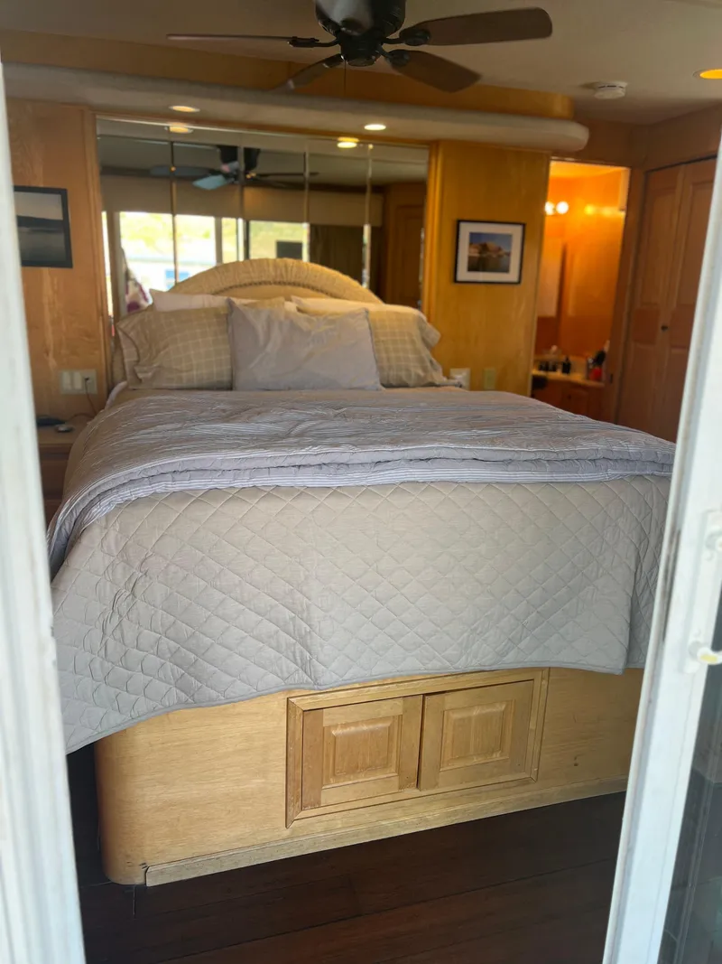 Slide: The Image of Cozy bedroom in 2002 Sharpe houseboat with wooden decor and ceiling fan. - 34