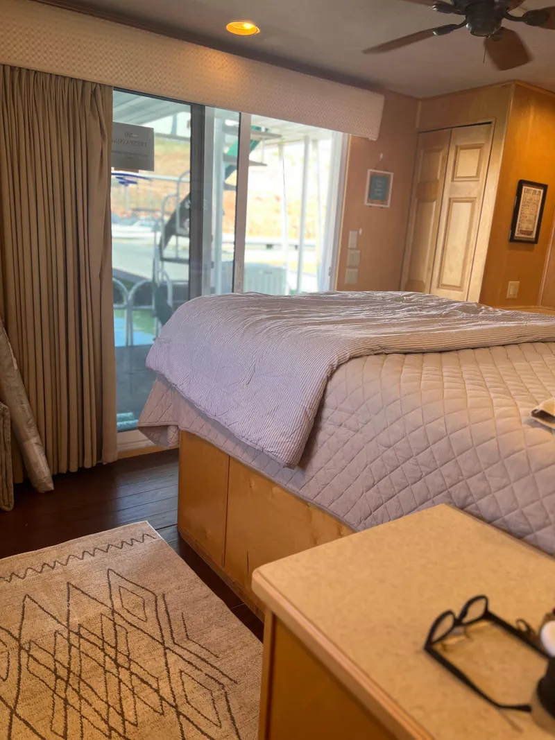 Slide: The Image of Cozy bedroom in a 2002 Sharpe houseboat with a large window and modern decor. - 36