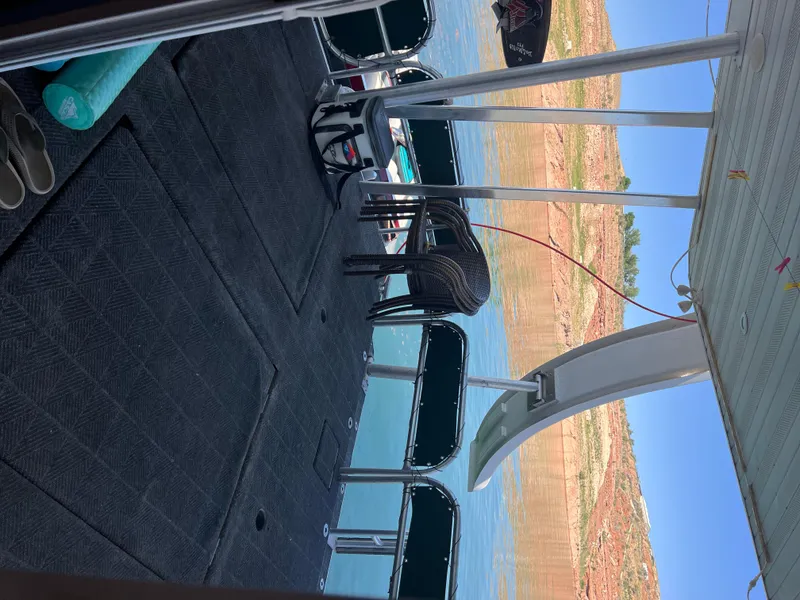 Slide: The Image of Houseboat interior with lake view, featuring chairs and a slide, Sharpe model 2002. - 37