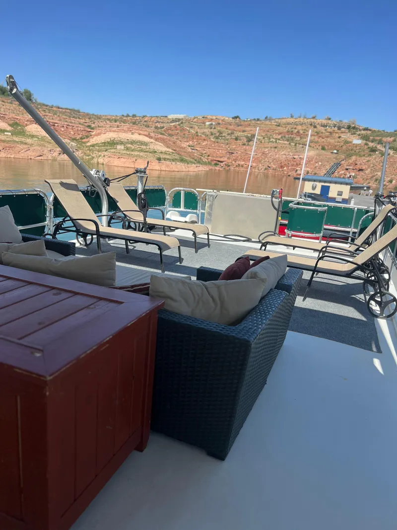 Slide: The Image of 2002 Sharpe houseboat deck with lounge chairs and scenic water view. - 39