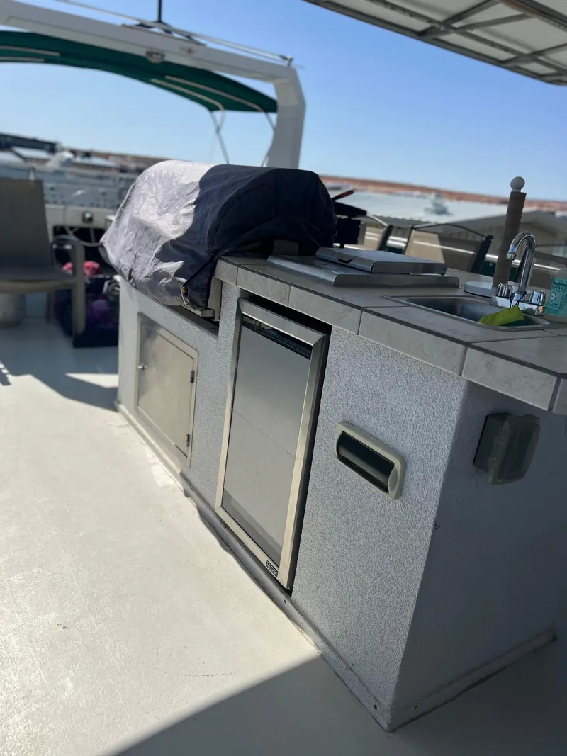 Slide: The Image of Outdoor kitchen on a 2002 Sharpe houseboat with covered grill and stainless steel appliances. - 41