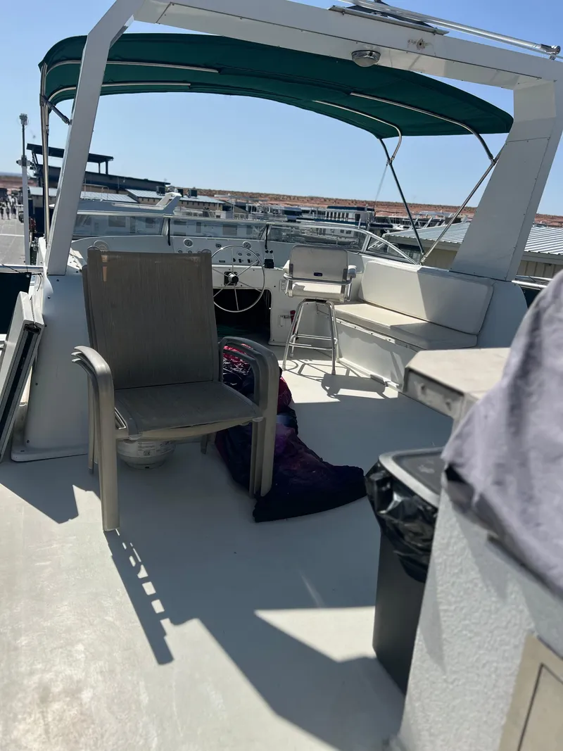 Slide: The Image of 2002 Sharpe houseboat deck with chairs, canopy, and marina view. - 42