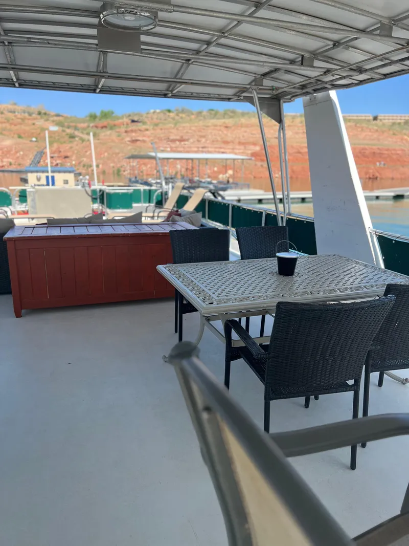 Slide: The Image of 2002 Sharpe houseboat deck with dining area and scenic marina view. - 44