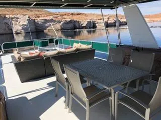 Slide: The Image of 2002 Sharpe houseboat deck with outdoor seating, dining table, and scenic water view. - 49