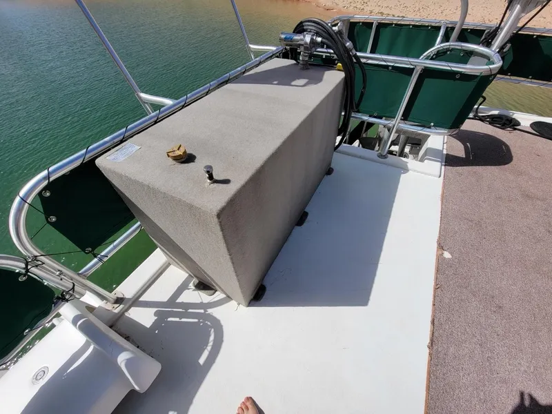 Slide: The Image of 2002 Sharpe houseboat deck with equipment and railing, overlooking water. - 5