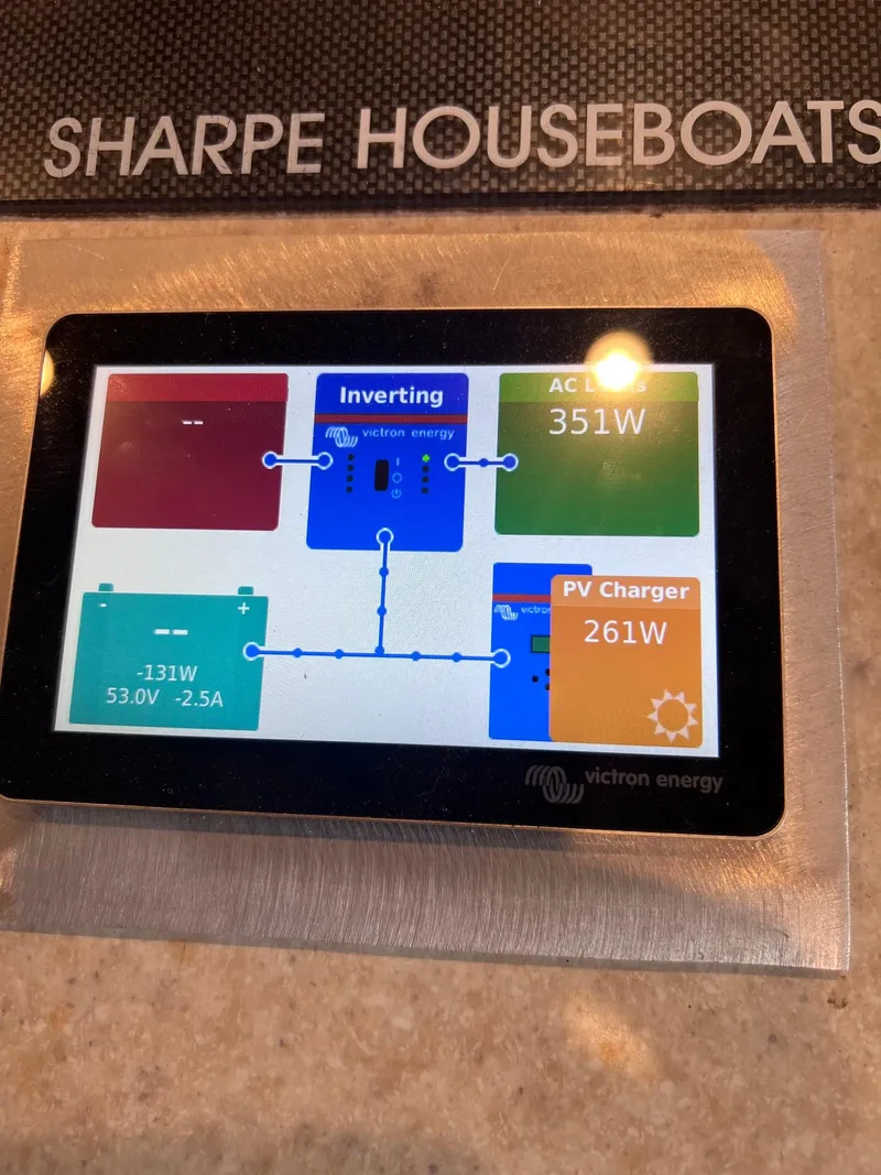 Slide: The Image of Control panel on a 2002 Sharpe houseboat displaying energy usage and inverter status. - 7