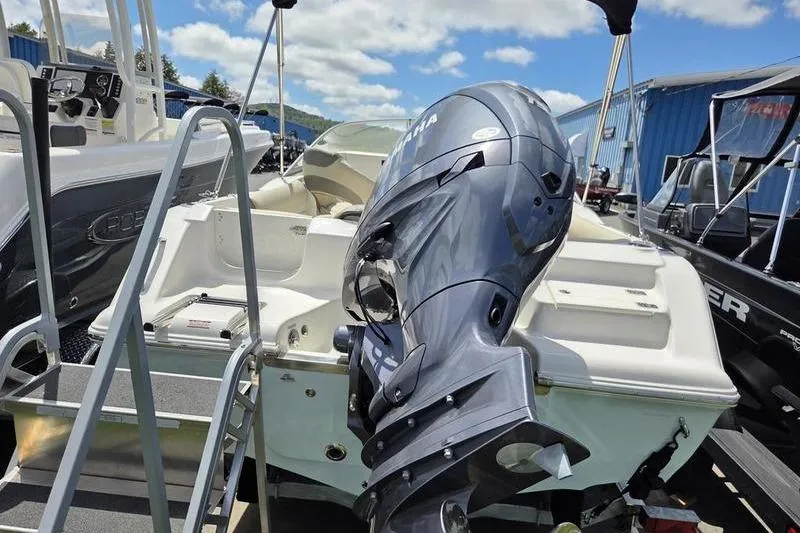 Slide: The Image of 2025 Key West 203 DFS boat with Yamaha outboard motor, docked under a sunny sky. - 13
