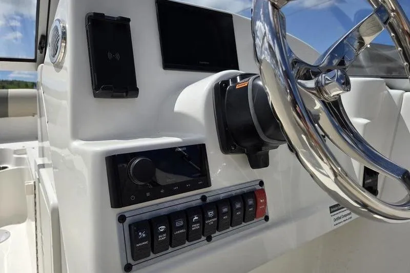 Slide: The Image of Control panel of 2025 Key West 203 DFS boat with steering wheel and switches. - 4