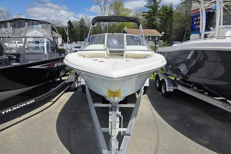 Slide: The Image of 2025 Key West 203 DFS boat on trailer, parked between two other boats. - 6