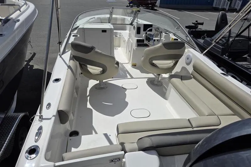 Slide: The Image of 2025 Key West 203 DFS boat interior with seating and steering console. - 8