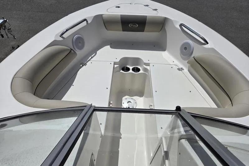 Slide: The Image of 2025 Key West 203 DFS boat interior with cushioned seating and cup holders. - 9