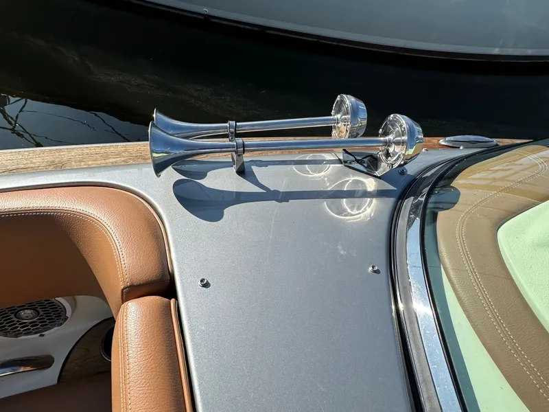 Slide: The Image of 2013 Chris-Craft Launch 25 boat with chrome horns and tan leather interior. - 12