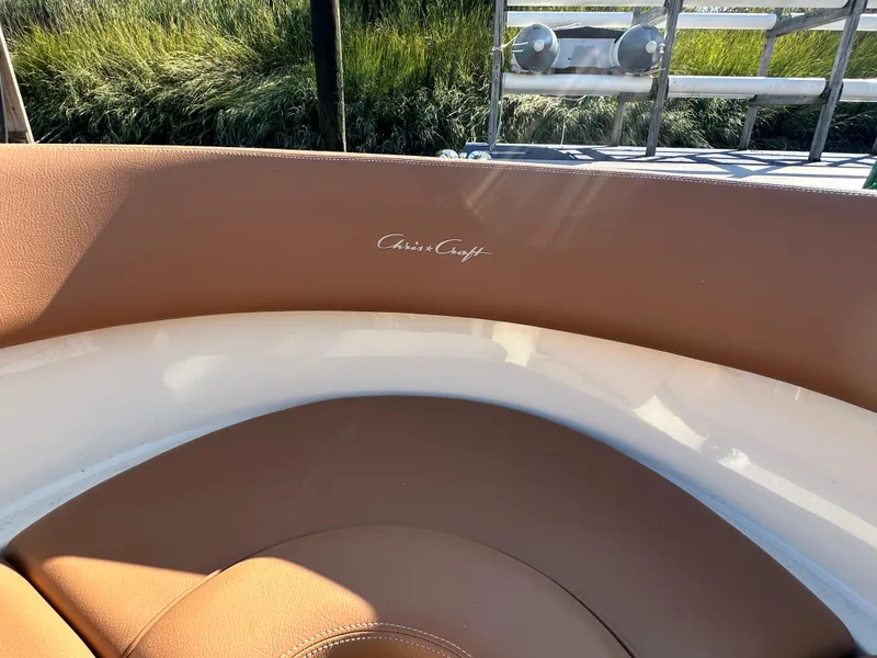 Slide: The Image of 2013 Chris-Craft Launch 25 boat interior with tan leather seating and logo. - 14