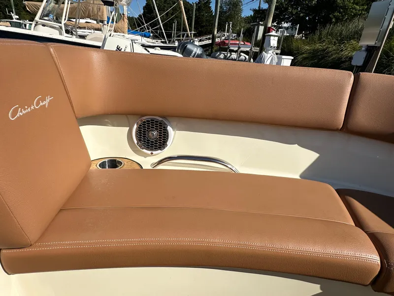Slide: The Image of 2013 Chris-Craft Launch 25 boat interior with tan leather seating and speaker. - 15