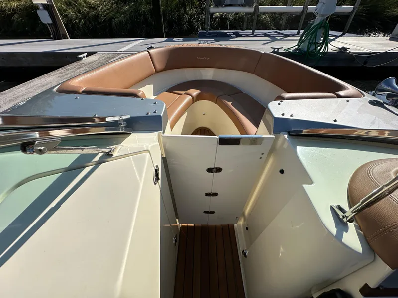 Slide: The Image of 2013 Chris-Craft Launch 25 boat interior with tan seating and wooden flooring. - 16