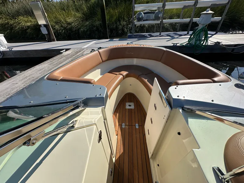 Slide: The Image of 2013 Chris-Craft Launch 25 boat with tan seating and wooden deck. - 17