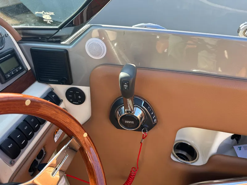 Slide: The Image of 2013 Chris-Craft Launch 25 boat dashboard with steering wheel and controls. - 19