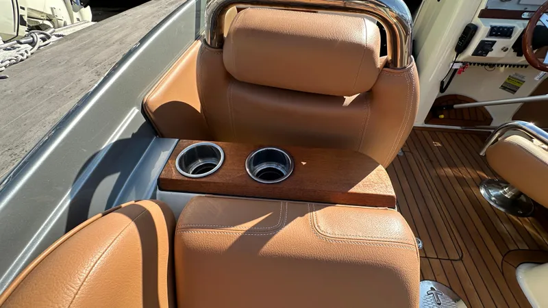 Slide: The Image of 2013 Chris-Craft Launch 25 interior with tan leather seats and cup holders. - 21