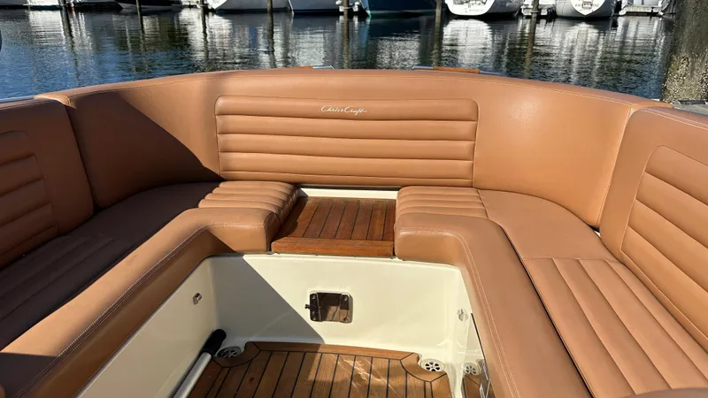Slide: The Image of 2013 Chris-Craft Launch 25 boat interior with tan leather seating and wooden flooring. - 23