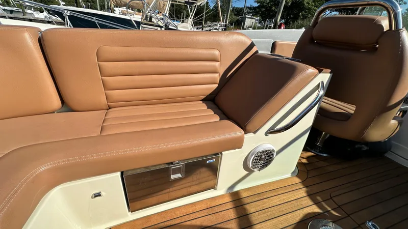 Slide: The Image of 2013 Chris-Craft Launch 25 interior with tan leather seating and wood accents. - 25