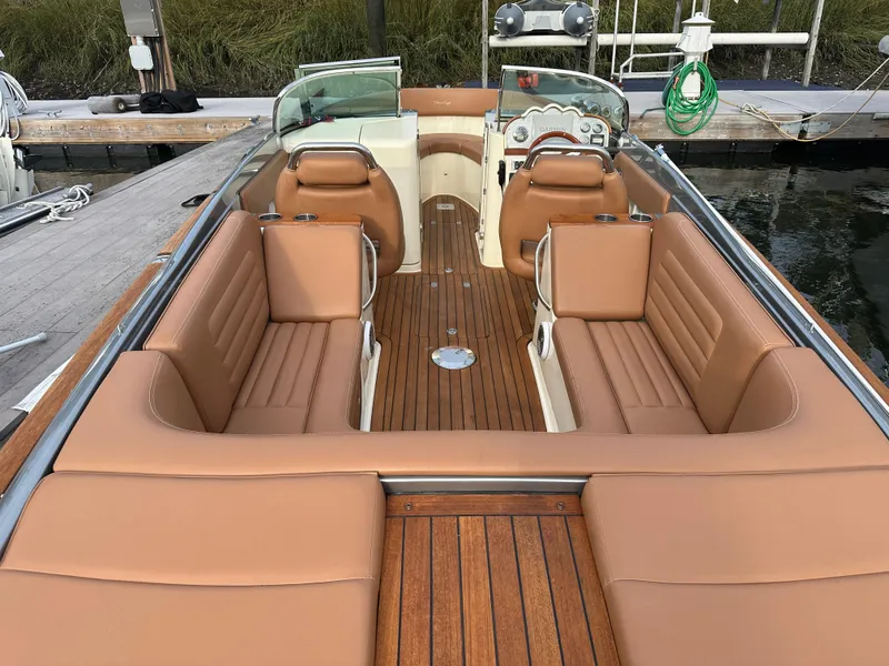 Slide: The Image of 2013 Chris-Craft Launch 25 boat with tan leather seating and wooden deck. - 3