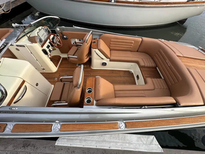 Slide: The Image of 2013 Chris-Craft Launch 25 boat with luxurious tan leather interior and wooden accents. - 8