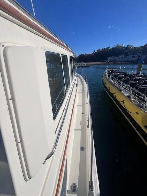 Slide: The Image of 1989 Blue Seas Out Island Explorer docked beside a yellow boat. - 10