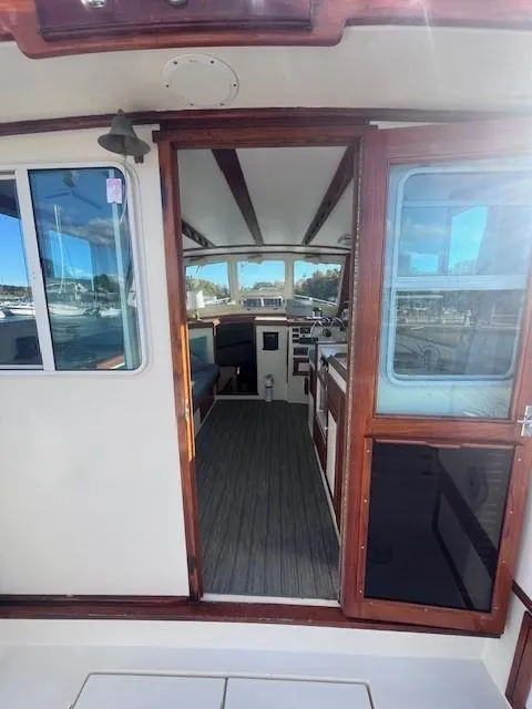 Slide: The Image of 1989 Blue Seas Out Island Explorer boat interior with wooden trim and large windows. - 13