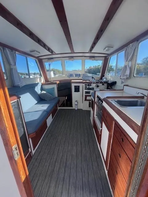 Slide: The Image of Interior of 1989 Blue Seas Out Island Explorer boat with wood accents and seating. - 14