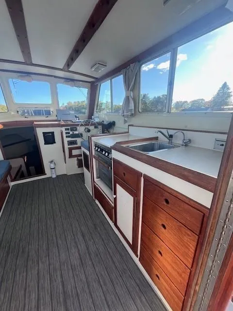 Slide: The Image of Interior of 1989 Blue Seas Out Island Explorer boat with kitchen and steering area. - 15