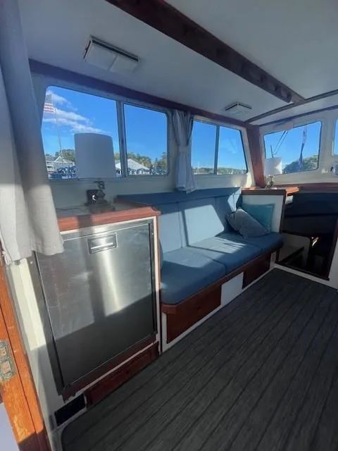 Slide: The Image of Interior of 1989 Blue Seas Out Island Explorer boat with seating and windows. - 16