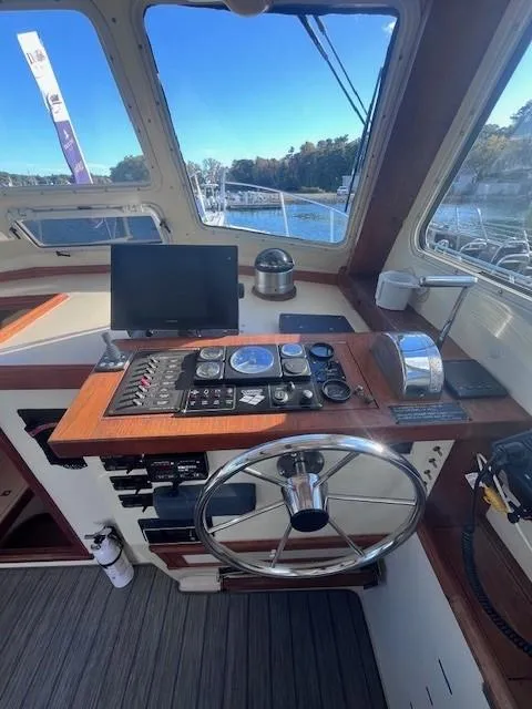 Slide: The Image of 1989 Blue Seas Out Island Explorer helm with navigation instruments and steering wheel. - 17