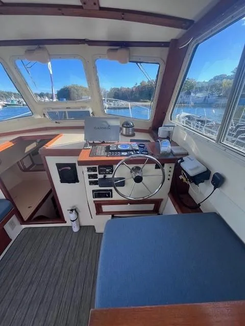 Slide: The Image of Interior of 1989 Blue Seas Out Island Explorer boat with steering wheel and navigation equipment. - 20
