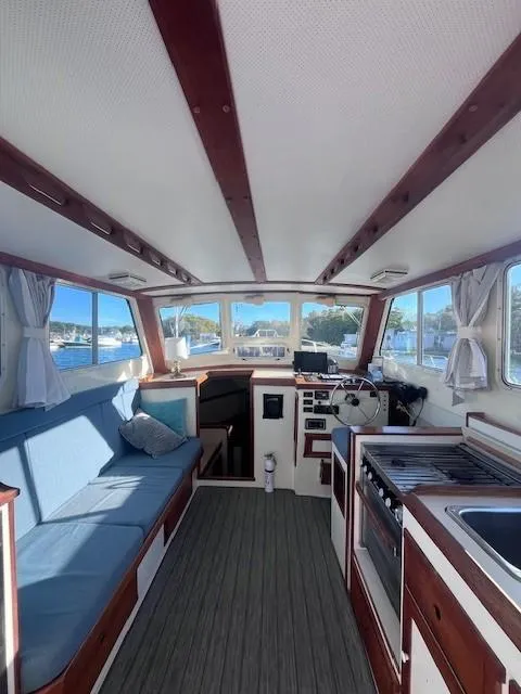 Slide: The Image of Interior of 1989 Blue Seas Out Island Explorer boat with seating and kitchen area. - 24