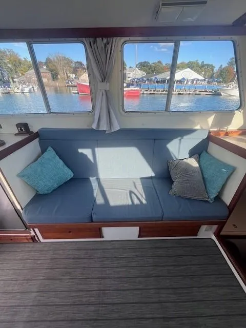 Slide: The Image of Interior of 1989 Blue Seas Out Island Explorer with cozy seating and scenic window view. - 25