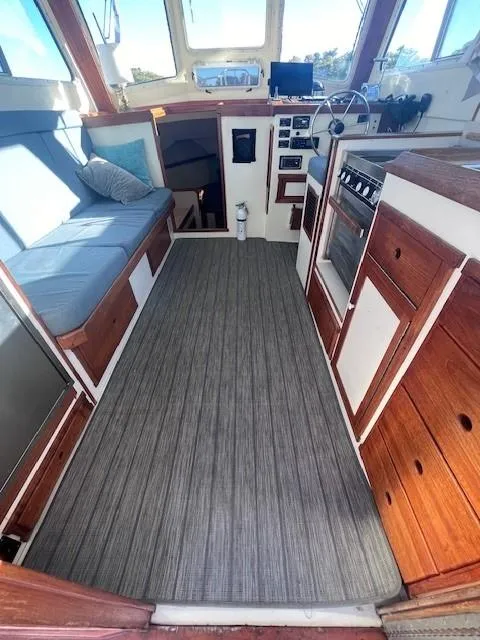 Slide: The Image of 1989 Blue Seas Out Island Explorer boat interior with wood cabinetry and seating. - 26