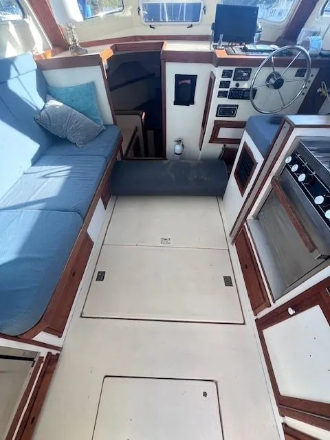 Slide: The Image of Interior of 1989 Blue Seas Out Island Explorer boat with seating and navigation area. - 27