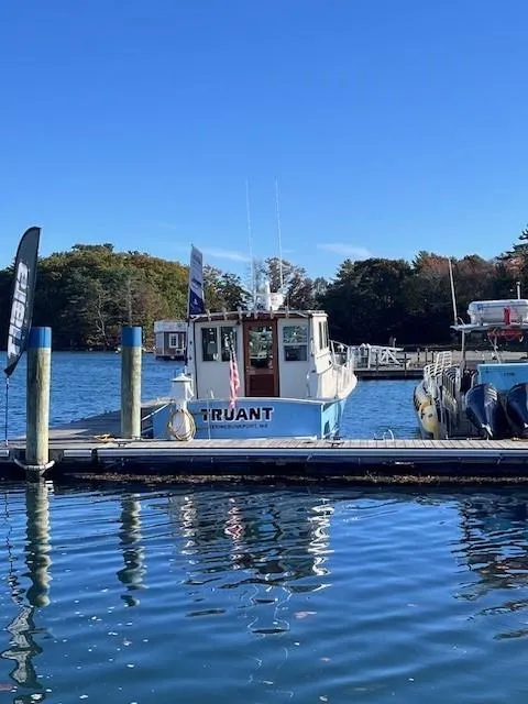 Slide: The Image of 1989 Blue Seas Out Island Explorer boat docked at marina on sunny day. - 32