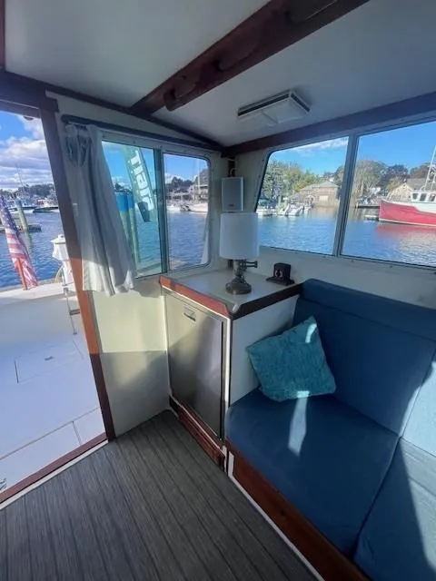 Slide: The Image of Interior of 1989 Blue Seas Out Island Explorer boat with cozy seating and waterfront view. - 38