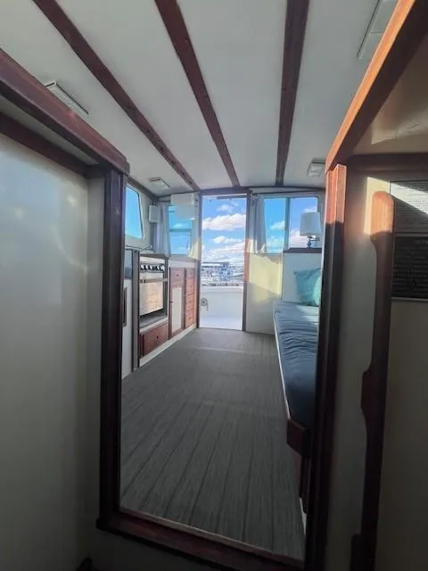 Slide: The Image of Interior of 1989 Blue Seas Out Island Explorer boat with cozy seating and kitchen area. - 39