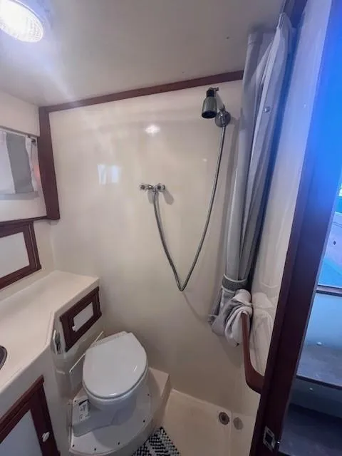 Slide: The Image of 1989 Blue Seas Out Island Explorer bathroom with shower, toilet, and sink. - 41