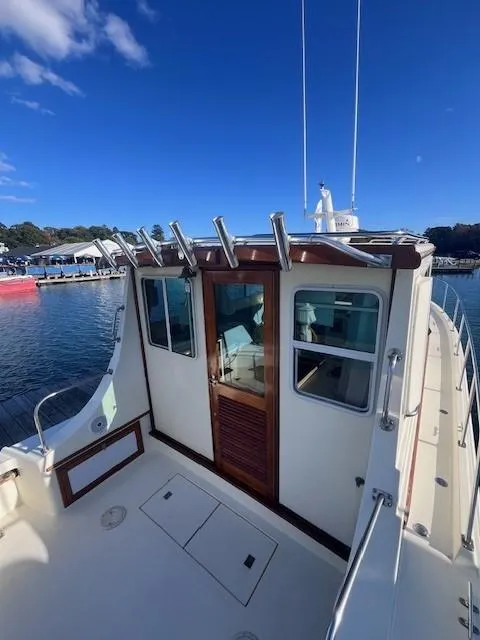 Slide: The Image of 1989 Blue Seas Out Island Explorer boat docked at marina under clear blue sky. - 8