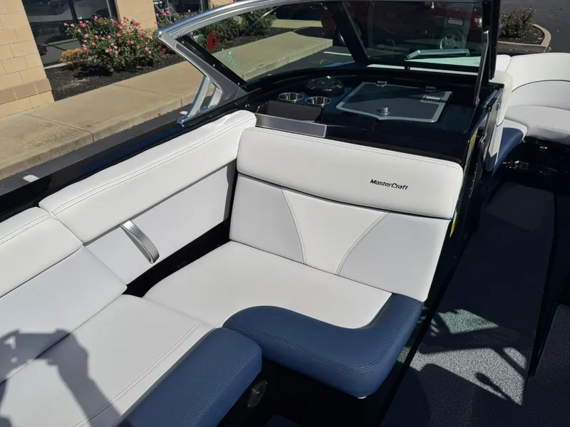 Slide: The Image of 2019 MasterCraft XT23 boat interior with white and blue seating. - 10