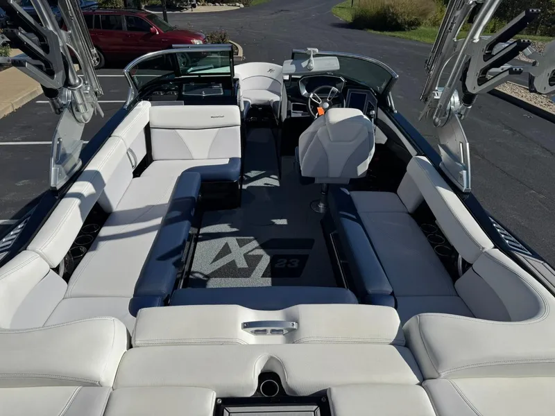 Slide: The Image of 2019 MasterCraft XT23 boat interior with white seating and sleek design. - 12
