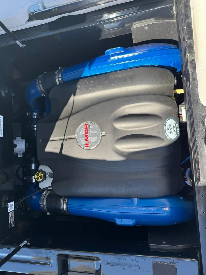 Slide: The Image of 2019 MasterCraft XT23 engine compartment with Ilmor engine, blue accents. - 13