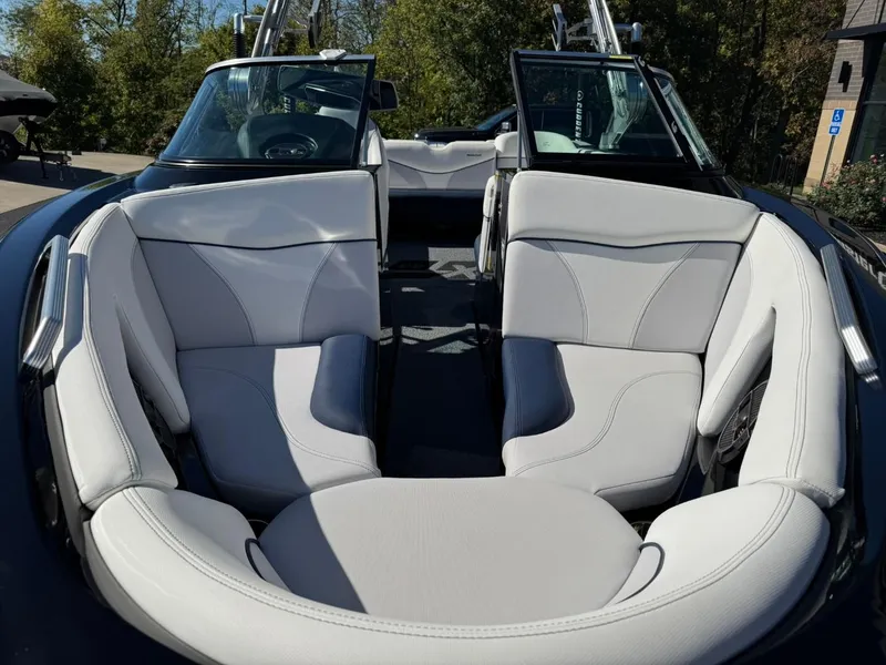 Slide: The Image of 2019 MasterCraft XT23 boat interior with white seating and open bow design. - 7