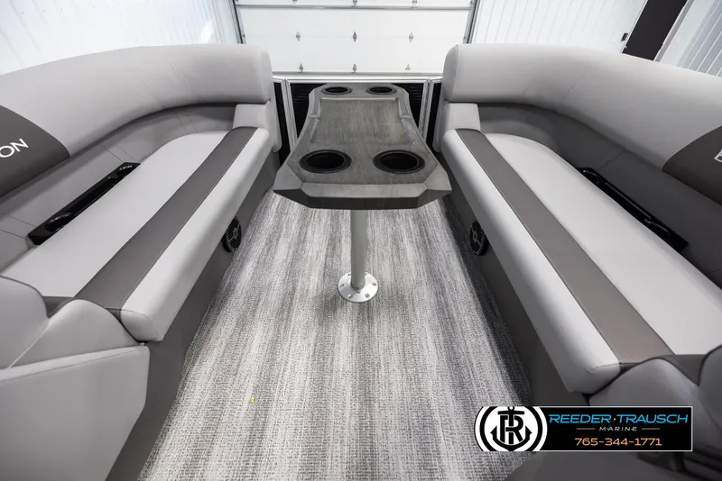 Slide: The Image of Interior of 2025 Bennington 21 SSBSE pontoon boat with gray seating and central table. - 20