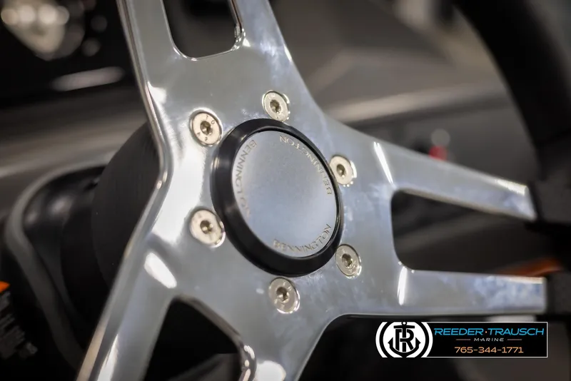Slide: The Image of Close-up of 2025 Bennington 21 SSBSE steering wheel with logo detail. - 26