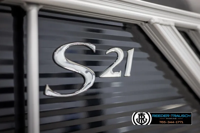 Slide: The Image of 2025 Bennington 21 SSBSE boat with sleek metallic "S21" emblem detail. - 47