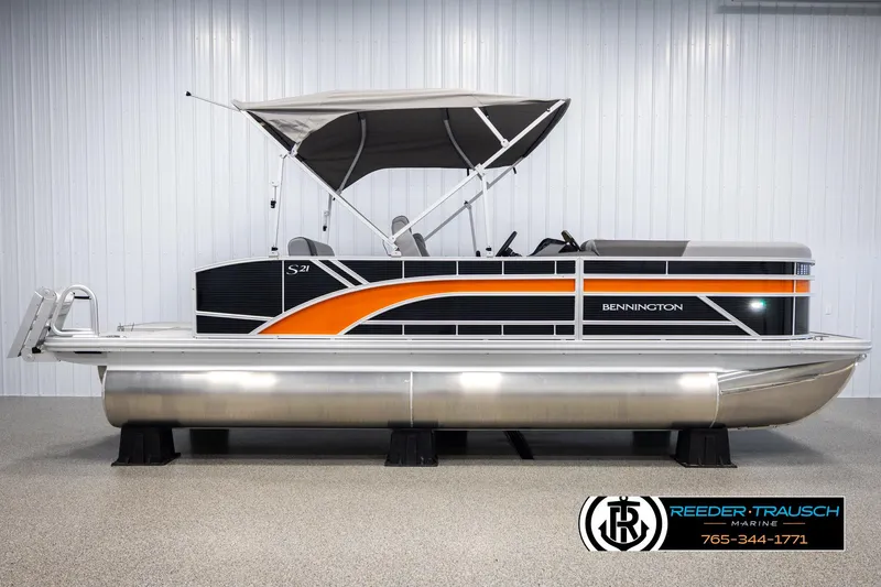 Slide: The Image of 2025 Bennington 21 SSBSE pontoon boat with orange and black design, displayed indoors. - 5